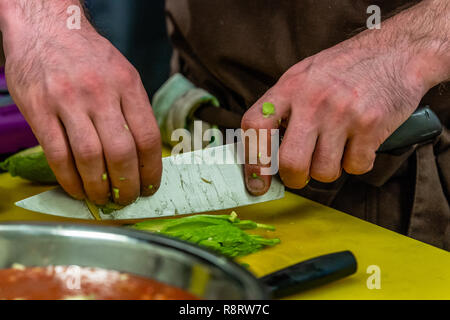 Male Chef Slicing Avocado for  Wedding Meal - Kitchen Set with Isolated Action, Only Chef`s Hands Stock Photo